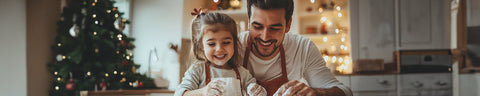 Vater und Tochter beim Backen im Hintergrund ein Weihnachtsbaum